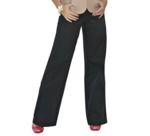 Black wide-leg pants paired with a beige blazer and red high-heeled sandals, hands on hips.