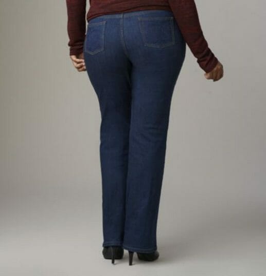 Woman in brown top, jeans and black heels