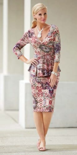 Woman in multi-color paisley print peplum top and matching pencil skirt