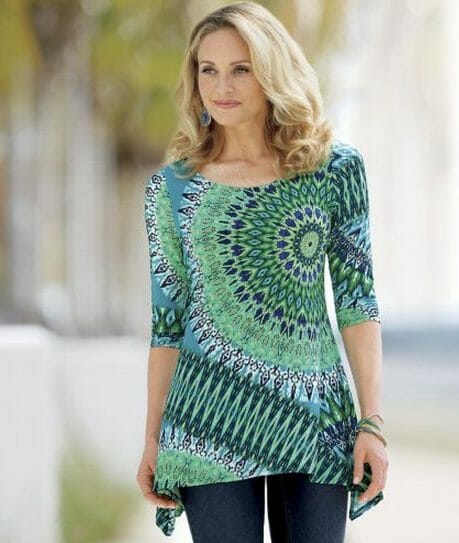 Woman in multi-green pattern top and blue pants