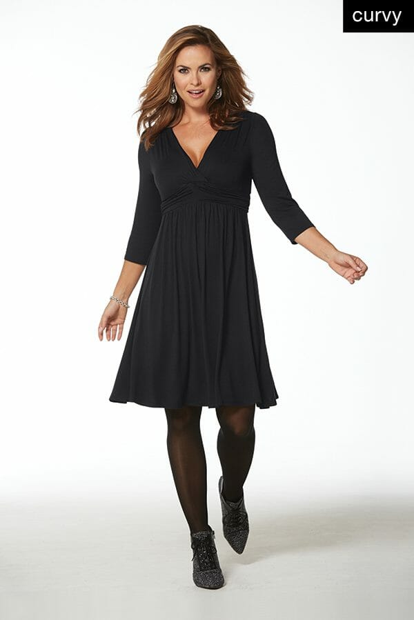 Woman in black elastic waisted dress with black shooties
