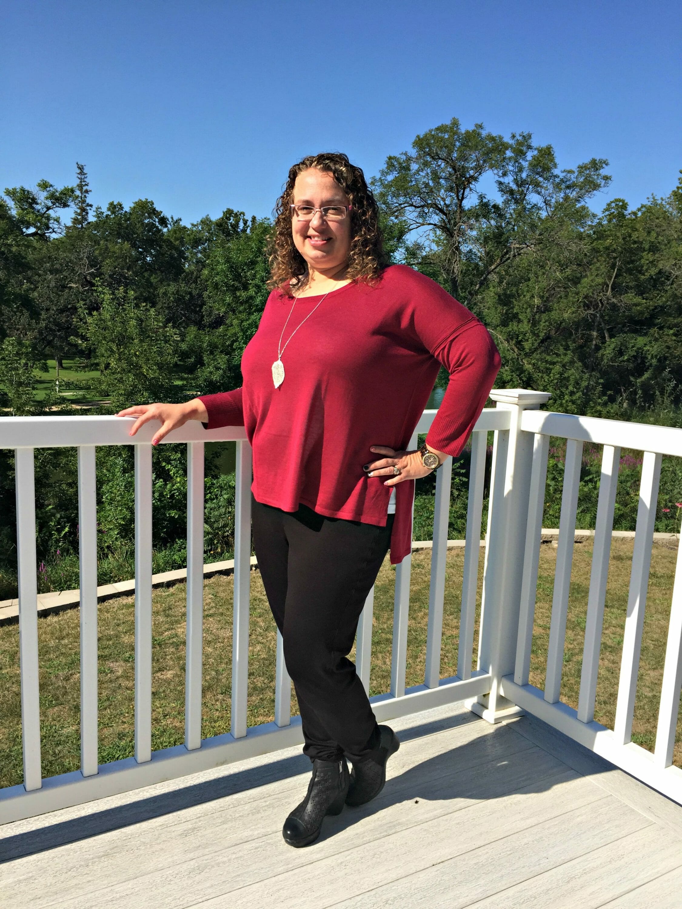 woman wearing merlot colored top and black pants 