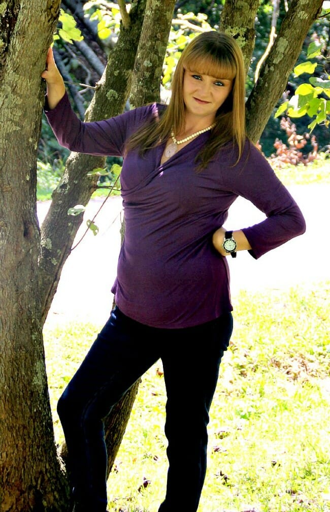 woman wearing aubergine top and black pants