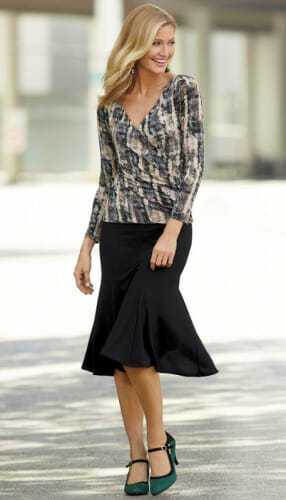 Woman in multi-color blouse and black mermaid skirt