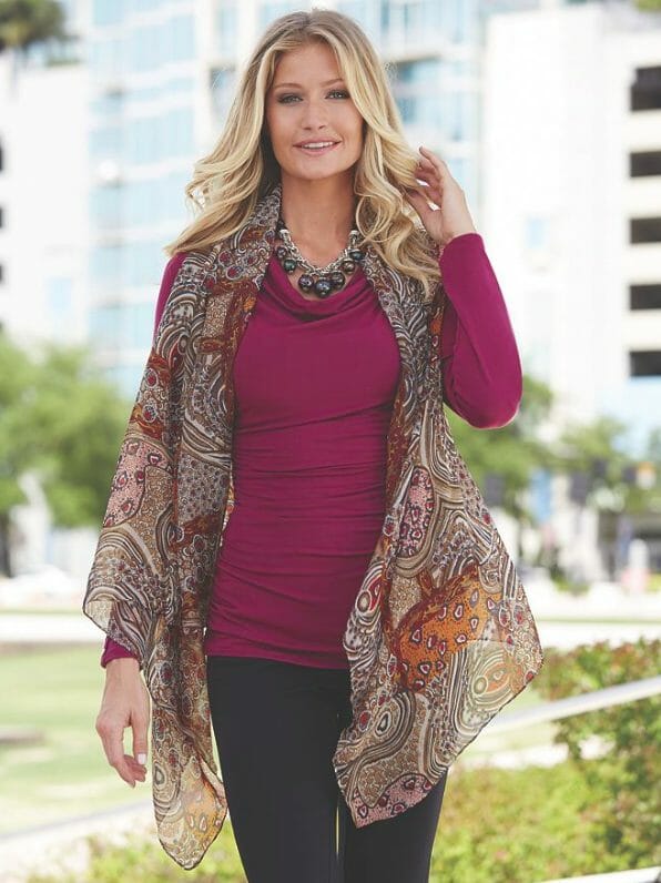 Woman in black pants, multi-colored sheer scarf vest over maroon top