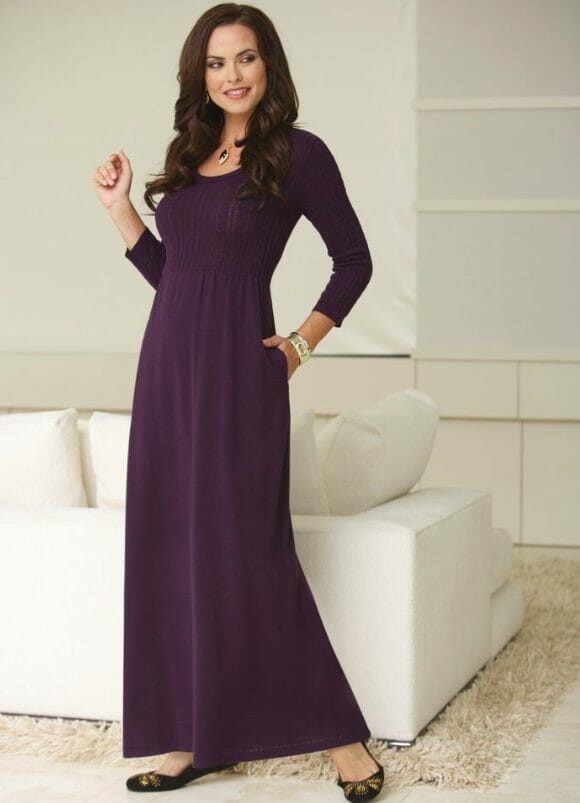 woman wearing a long plum sweater dress with black flats
