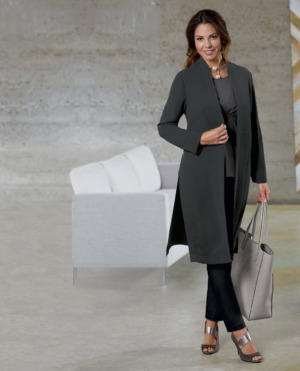 Woman in gray shoes, black pants, gray top and gray duster