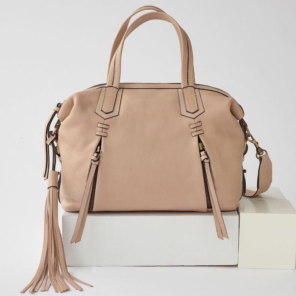 Beige purse with 2 outside zip pockets and tassel