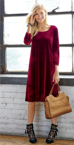 Woman wearing a red velvet dress and black multi-colored shooties