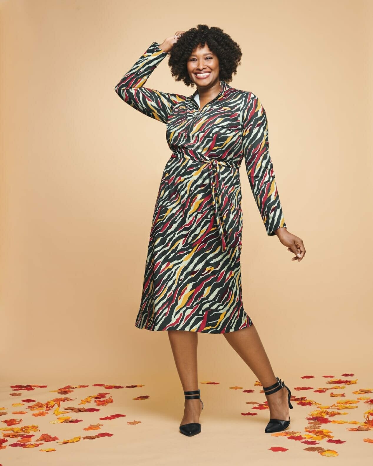 plus, sized model wearing a zebra printed long sleeve dress.