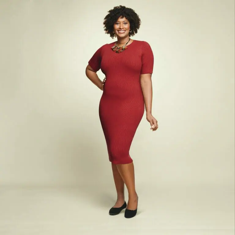 plus size model wearing burgundy knit dress.