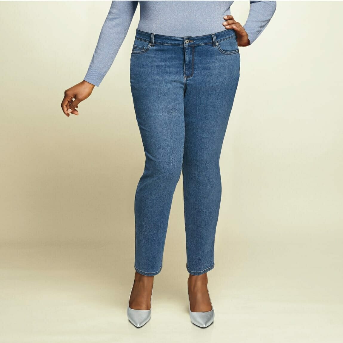 plus, sized model wearing jeans and silver metallic heels.