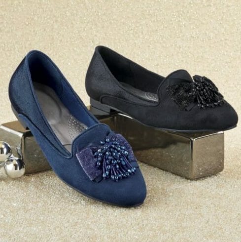 With the enchantment of a starlit night, these shimmering faux suede flats with glittering bows add charm to the evening.