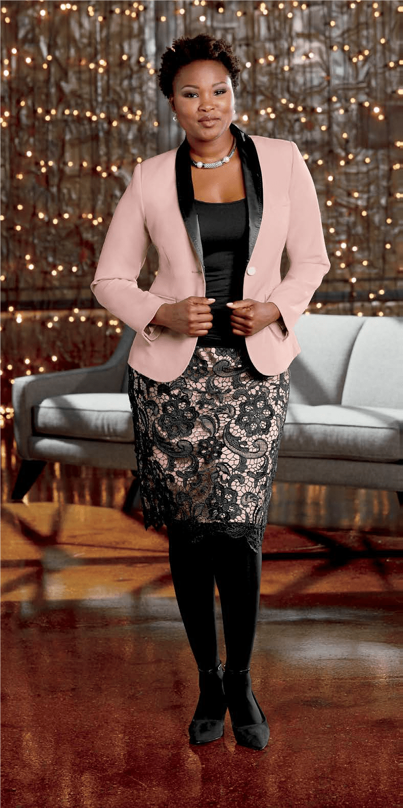 Woman wearing pink jacket and black and pink lace skirt