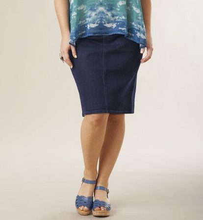Woman in blue-multi top, denim skirt and blue ankle strap wedges