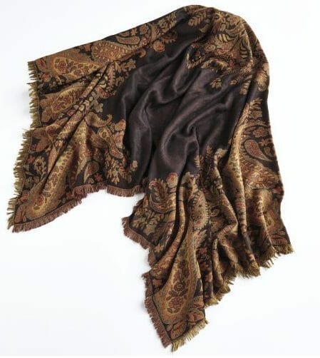 Blanket scarves, which are very large knit scarves that can be draped around the shoulders, are trending this winter. 