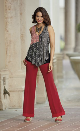 Woman in red and black pattern tunic, red pants and red heels