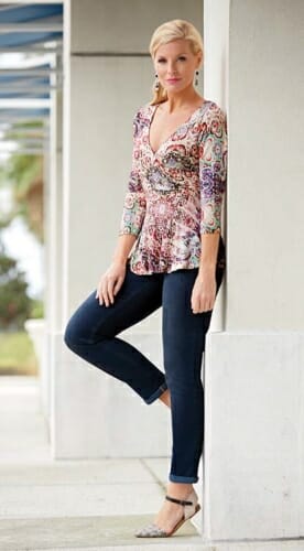 Woman in multi-color paisley top, jeans and closed-toe sandals