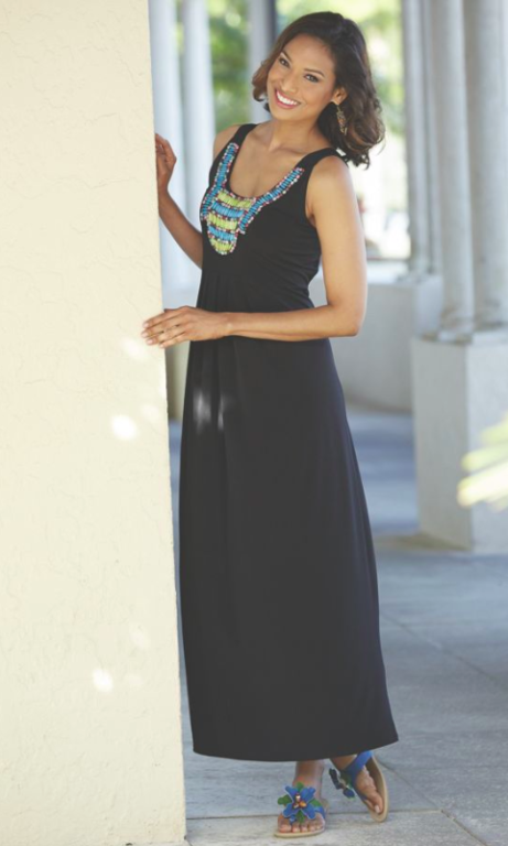 Woman in beaded black maxi dress and flip flops