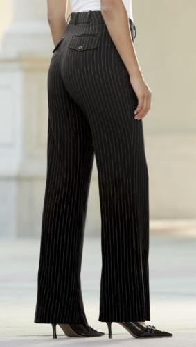 Woman wearing black heels, white top and black pin stripe trousers