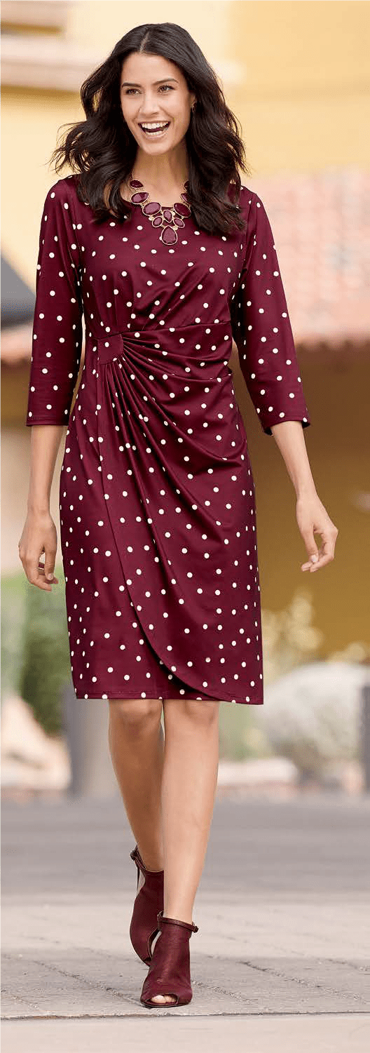 Woman wearing a maroon polka dot dress