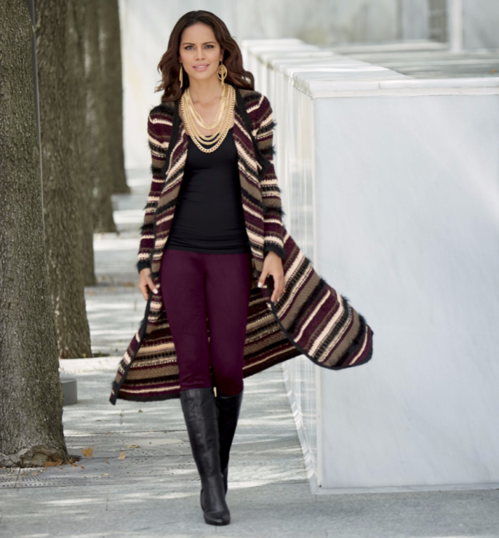 Woman wearing Gold Necklaces, black shirt, purple leggings and multi-stripe duster