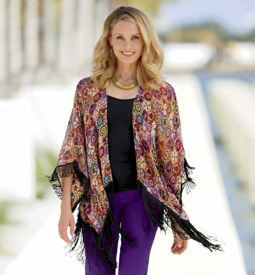 Woman wearing a colorful duster and purple pants