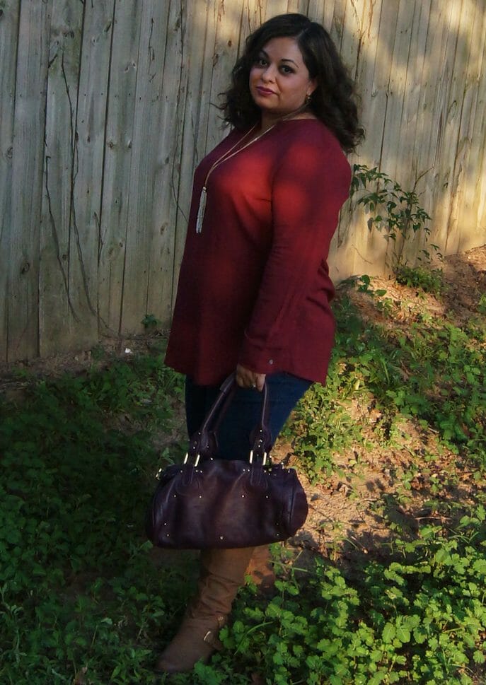woman wearing merlot top and bag and boots