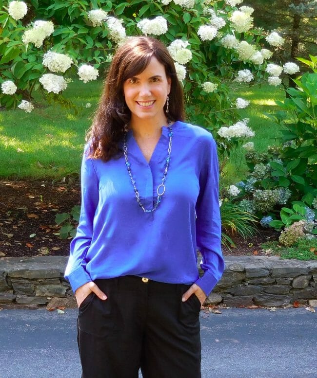 woman wearing cobalt blue top and black trousers