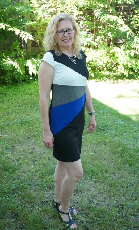 woman wearing fan-color dress with black, white, gray & cobalt blue