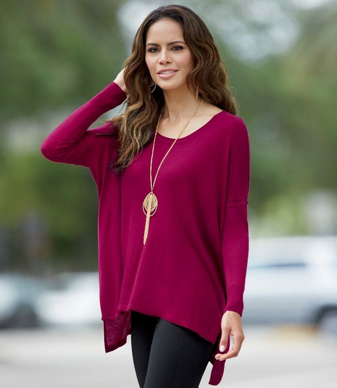 woman in merlot sweater, gold necklace and black pants