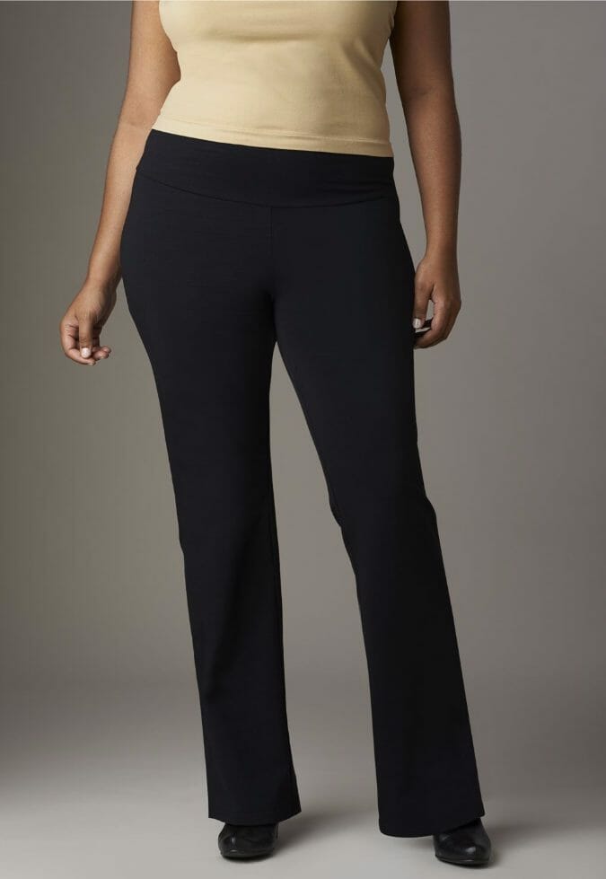 Woman in gold top, black pants and black shoes