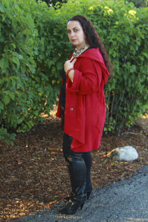 woman wearing red cape jacket and black boots