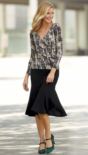 Woman in multi-color blouse and black mermaid skirt