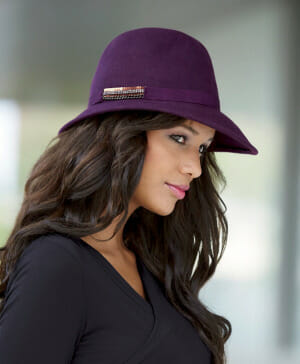 woman wearing a purple fedora hat and black shirt
