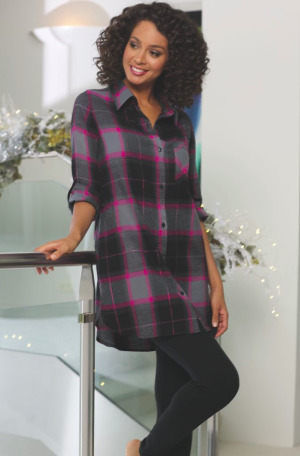 woman wearing a black and fuschia plaid flannel tunic with black leggings