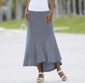 Woman in white wedges, blue and white striped skirt with fishtail hem and white top