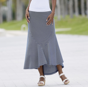 Woman in white wedges, blue and white striped skirt with fishtail hem and white top