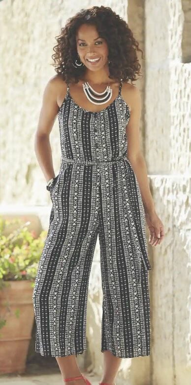 woman wearing a black and white geometric patterned cropped jumpsuit and red heels