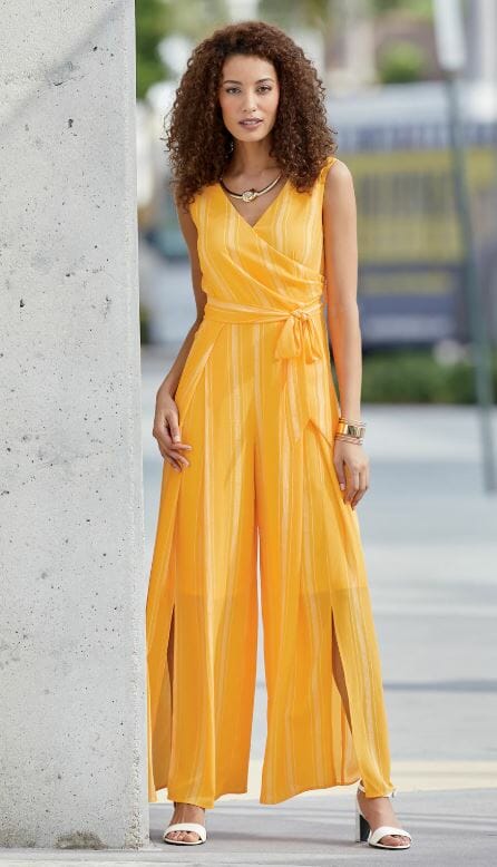 woman in gold jumpsuit made of stretch crepe fabric and white heeled sandals