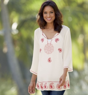 Woman in jeans and white and red embellished kurta top