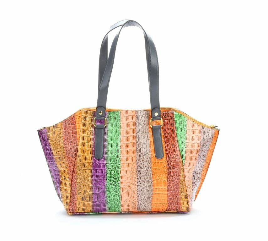 Classic handbag gets a wild makeover! It's a colorful striped bag with crocodile texture for the true fashionista. Goldtone grommets and details with zip closure. PVC shell. Three inside pockets. Lined. Imported. 21" l x 5" w x 12" h.