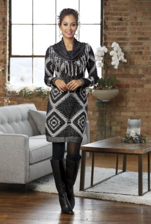 Woman in black high boots and black and white sweater dress with fringed collar