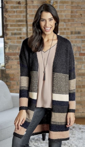 Woman in jeans, soft blush top and long cardigan in earth tones