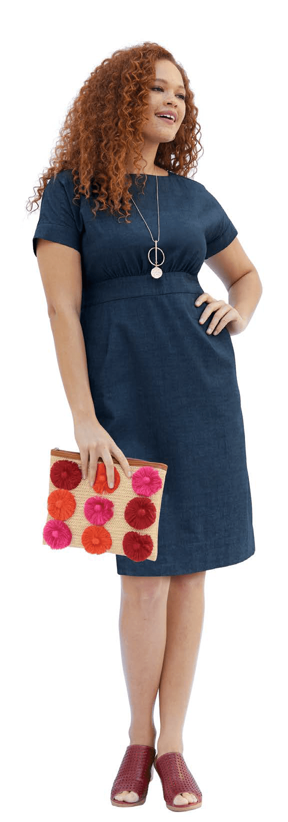 Woman wearing Denim Dress carrying colorful clutch