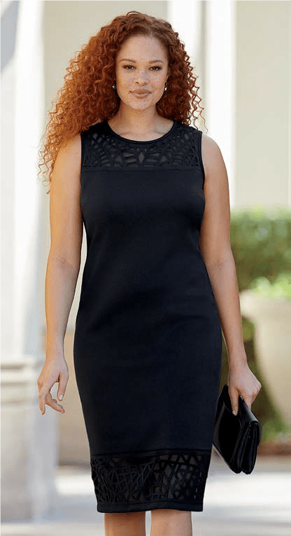 Woman wearing black scuba dress with cutout accents at collar and hem