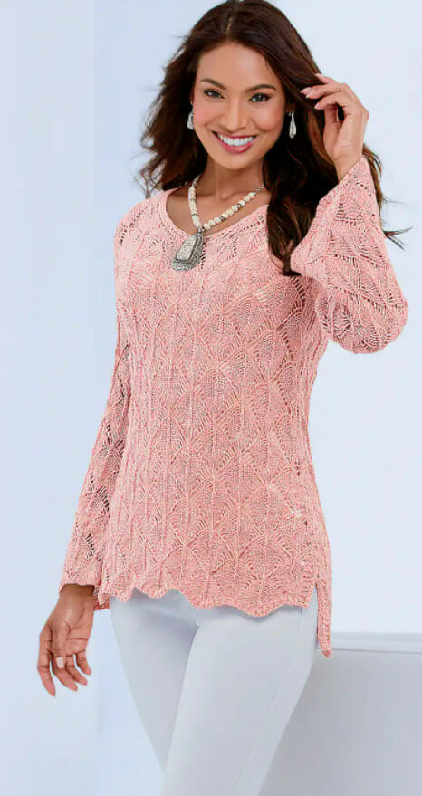 Women in light pink crochet long-sleeved top with pendant