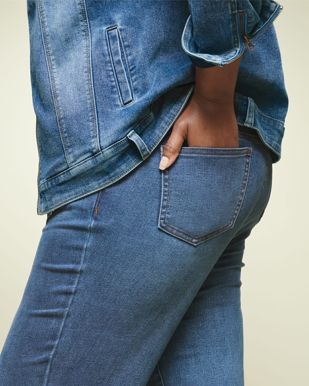 plus size woman wearing denim with hand in pocket