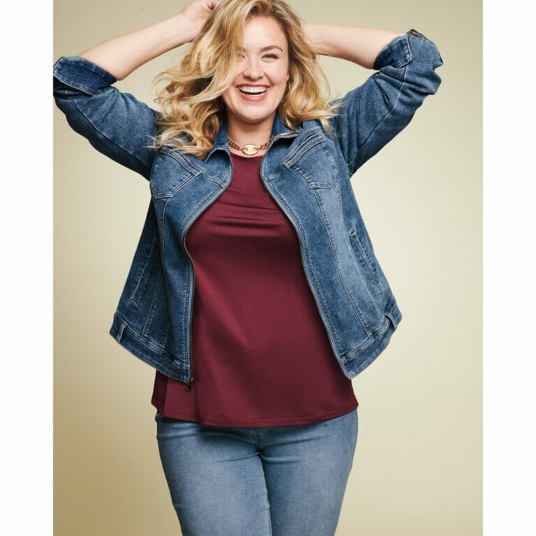 Plus size woman in denim jacket and jeans