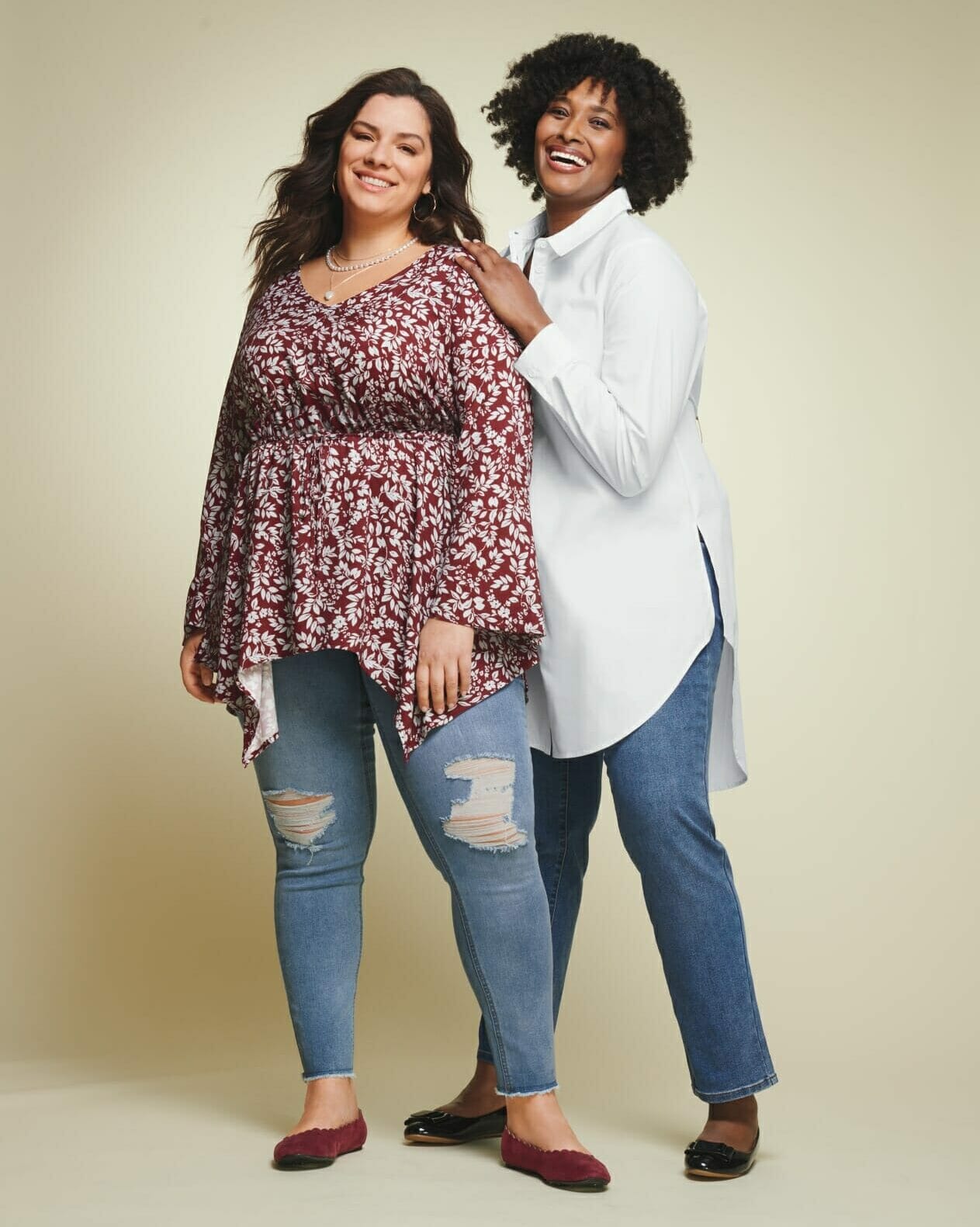 Two plus-size models with uneven top hemlines